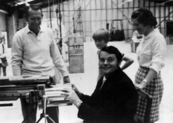Des Walker making a can, watched by Colin Stitt, his son and Yvonne Stitt, Avondale, 1 November, 1970